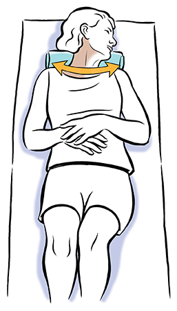 Woman lying on back doing active neck rotation exercise.